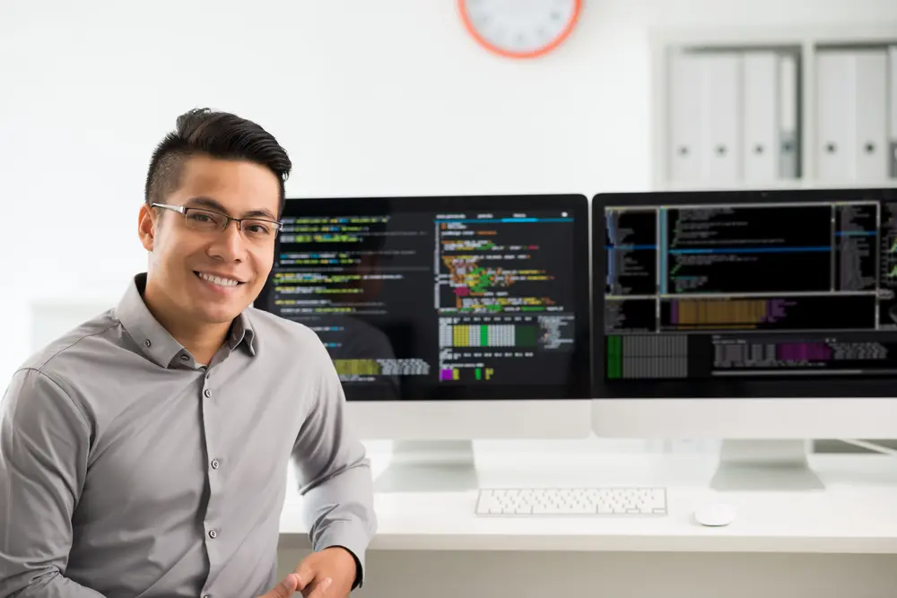 A smiling Vietnamese software engineer is shown in a portrait. This image represents the context of Agile Testing Services, highlighting the engineer's expertise in agile testing methodologies.