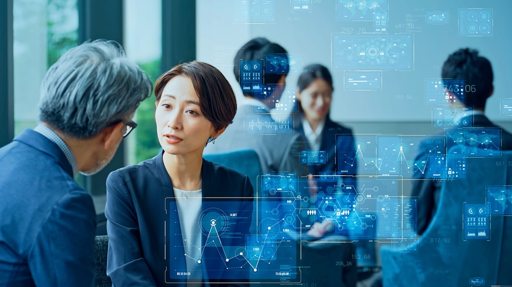 A group of businesspersons is engaged in data analysis, representing management strategy and the concept of IT Consulting Services, highlighting the integration of technology for informed decision-making.