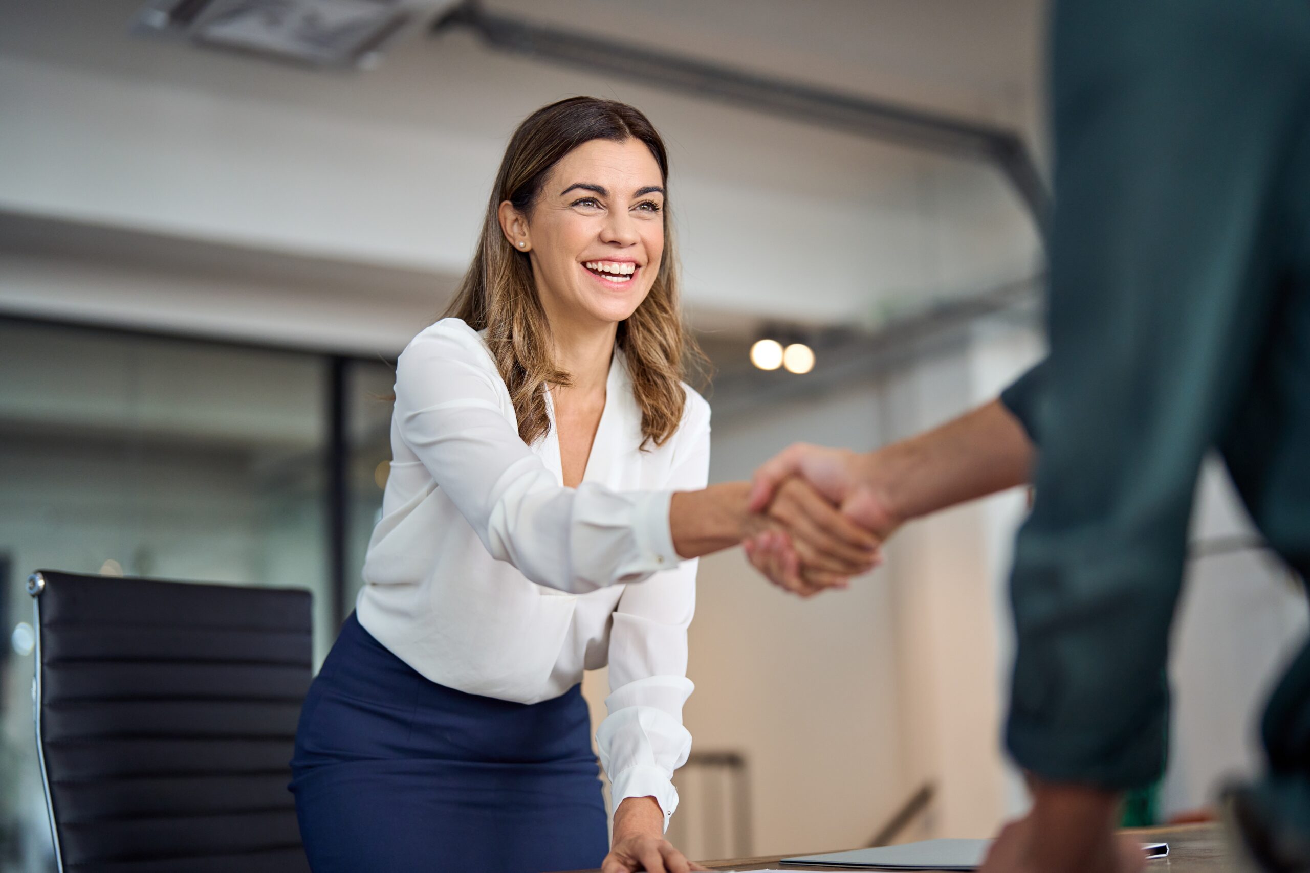 woman shaking business partner's hand