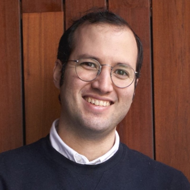 Headshot of Hireflix CEO Antonio Gonzalez in a black sweater with a white collared shirt underneath