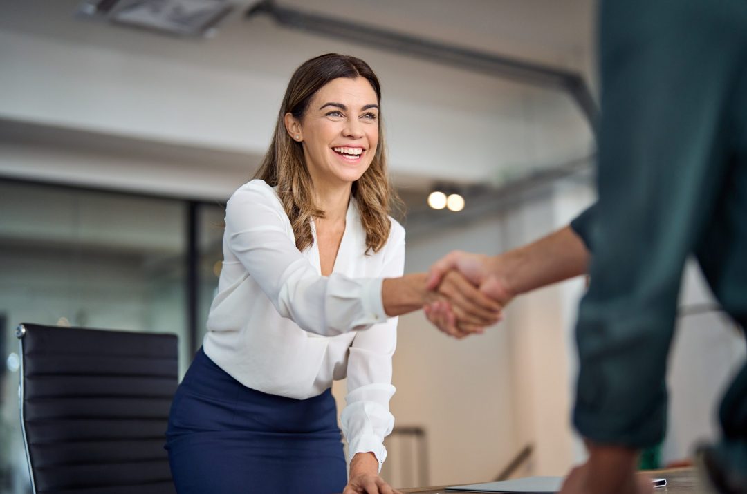 Happy,Mid,Aged,Business,Woman,Manager,Handshaking,Greeting,Client,In two business people shaking hands