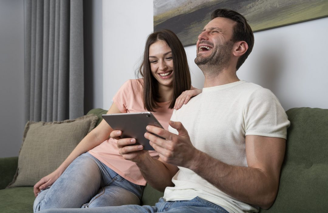 couple enjoying video accessibility watching content on tablet