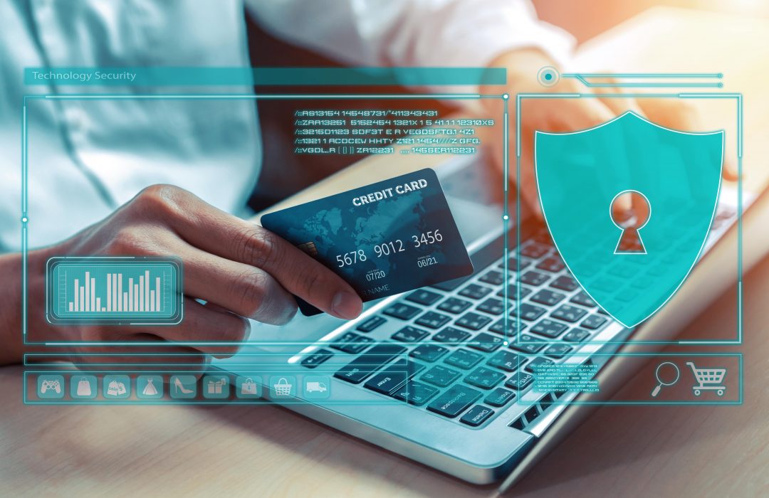elegant-customer-with-hologram-using-credit-card-authentication-cybercash-min professional holding credit card using a laptop with a cybersecurity graphic overlay, demonstrating saving money