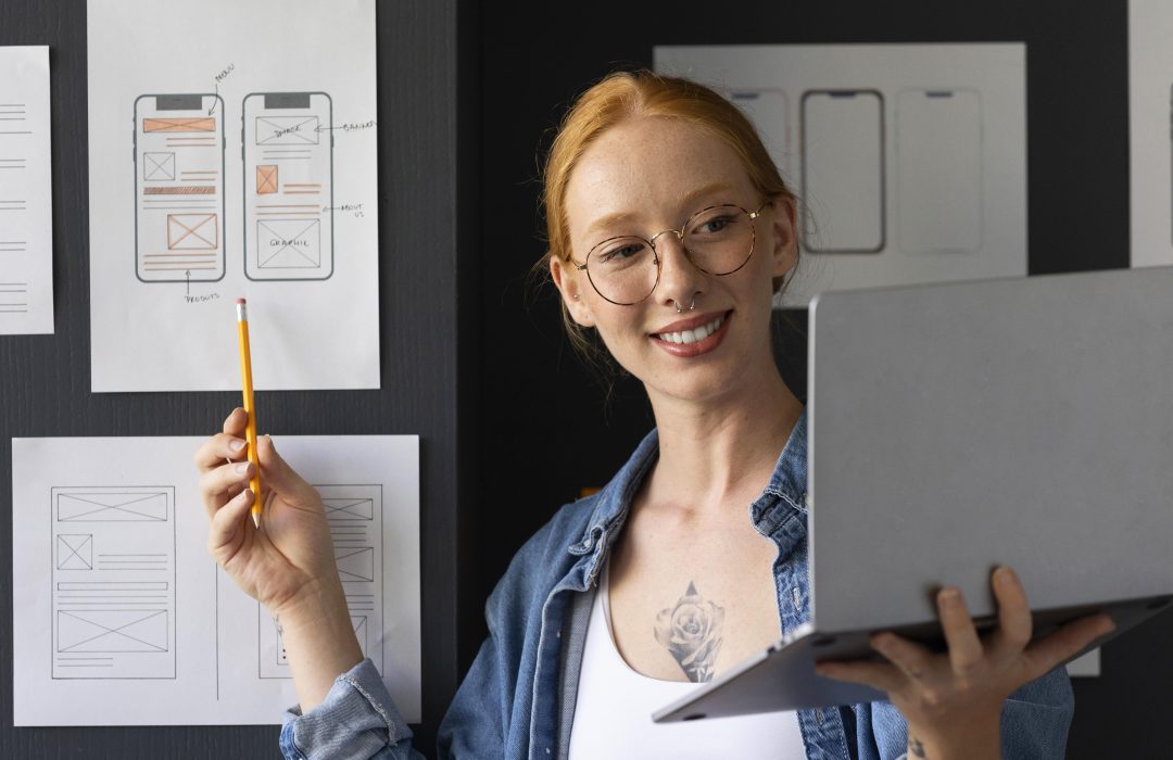 female web designer showing user experience changes on a mobile device