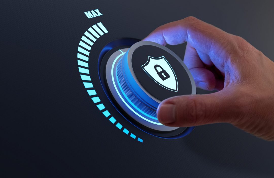 Security,Concept,With,Person,Increasing,The,Protection,Level,By,Turning cybersecurity knob with a person's hand turning it all the way up to max security