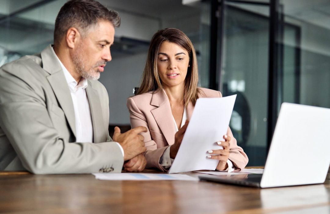 Business,Woman,Lawyer,Manager,Holding,Legal,Documents,Consulting,Mature,Older business man and woman having a consultation about hipaa compliance