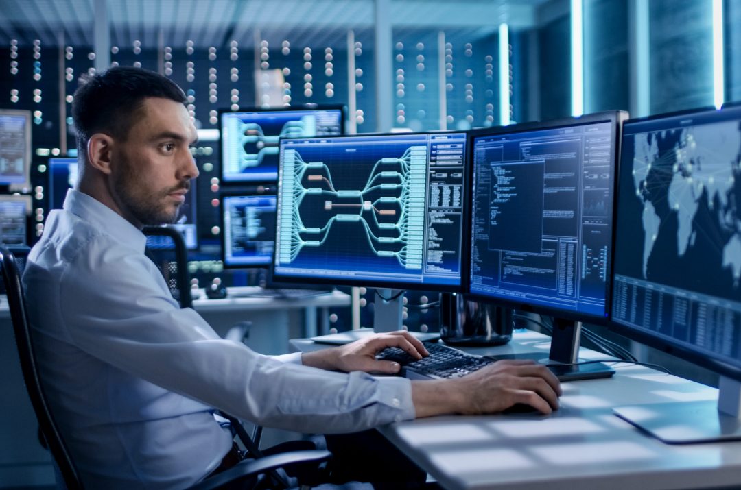 System,Security,Specialist,Working,At,System,Control,Center.,Room,Is it professional working at desk with computer monitors