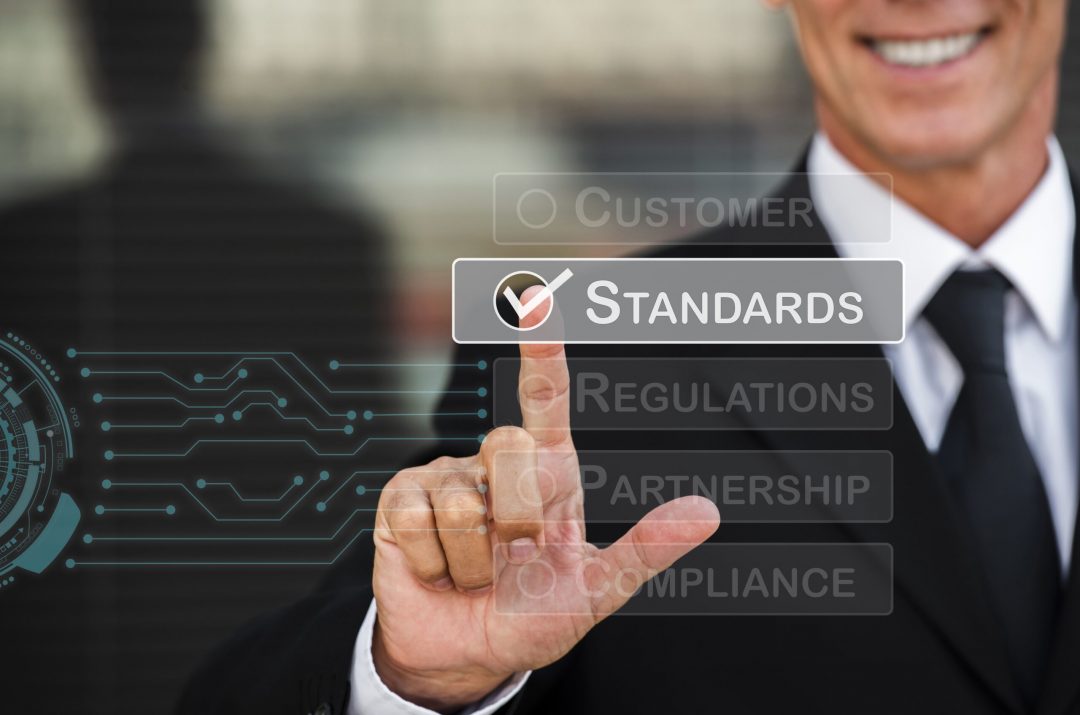 standard-quality-control-collage-min man checking off business standards for compliance