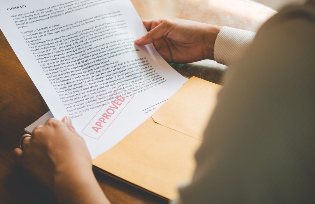 woman holding contract thats approved